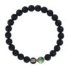 Czarna bransoletka z kulkami i zielonym koralikiem.