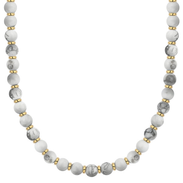 Naszyjnik z białymi kamieniami i złotymi elementami.