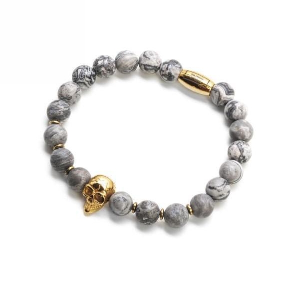 Bransoletka z szarymi kulkami i złotą czaszką.