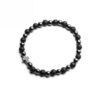 Czarna bransoletka z kulistymi koralikami i zawieszką w kształcie krzyża.