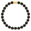 Czarna bransoletka z kulkami i złotymi przekładkami.